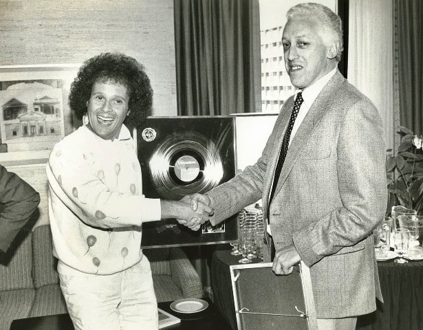 Nick Hampton presenting Richard Simmons with an ARIA Gold Record